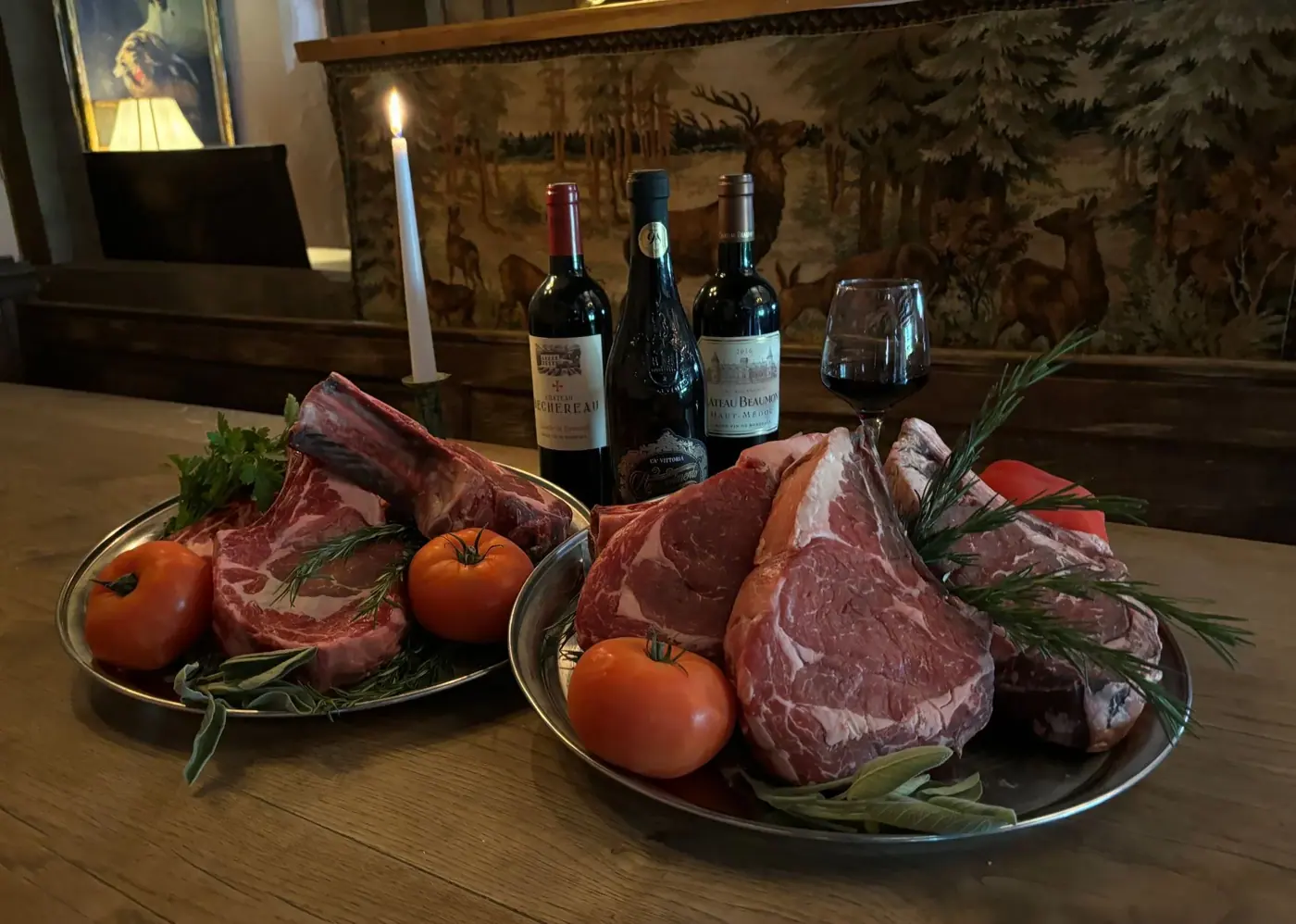 Belted Galloway cuts, tomatoes and red wine on a wooden table